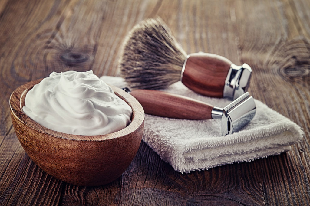 Shaving accessories on wooden background